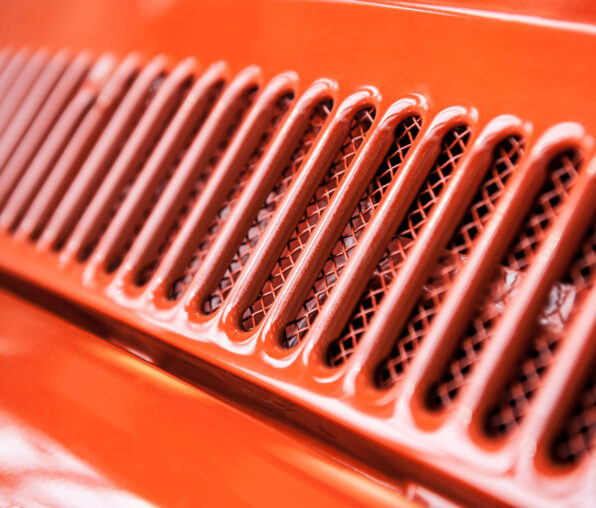 Abstract cooling grill detail of a red vintage car