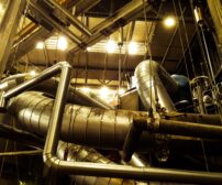 low-angle-view-pipelines-illuminated-factory