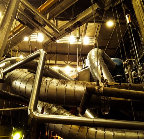 low-angle-view-pipelines-illuminated-factory